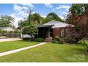 Quaint brick home with lush lawn and landscape at 1509 Wiltshire Rd, Salisbury, NC 21844