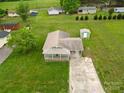 An aerial view of a home with a large yard, long driveway, and several neighboring houses nearby at 210 Stonefield Ln, Salisbury, NC 28146