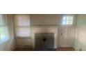 Cozy living room featuring a fireplace and natural light streaming through the window and adjacent doorway at 215 S Belvedere Ave, Gastonia, NC 28054