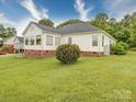 Expansive backyard featuring a well-maintained lawn, white siding, and mature trees at 2547 Bill Thompson Rd, Lancaster, SC 29720