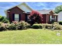 Beautifully landscaped front yard with colorful flowering bushes enhancing this classic brick home's curb appeal at 2547 Bill Thompson Rd, Lancaster, SC 29720