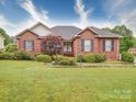 Charming brick home with manicured lawn, lovely shrubbery, and black shuttered windows at 2547 Bill Thompson Rd, Lancaster, SC 29720