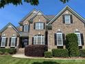 Charming brick home featuring a well-manicured lawn and manicured shrubs, providing a welcoming curb appeal and traditional style at 3000 J R Ct, Stanley, NC 28164