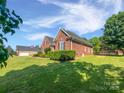 The spacious backyard and brick house offer a beautiful outdoor living space at 3124 Fairmead Dr, Concord, NC 28025