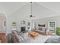 Bright living room with fireplace, vaulted ceiling, and views of the pool at 3124 Fairmead Dr, Concord, NC 28025
