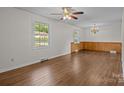 Inviting living room featuring hardwood floors, wainscotting, and a decorative chandelier at 322 S Vine St, Gastonia, NC 28052