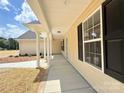 Covered porch with white support columns and large windows allowing natural light at 3650 Sentry Rd, Lancaster, SC 29720