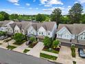 Aerial view of the townhome community featuring well-maintained landscaping, blue skies, and attached garages at 432 Belton St, Charlotte, NC 28209