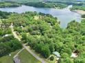 Scenic aerial view of a lake community surrounded by lush greenery and the lake at 4585 Sunrise Beach Rd, Catawba, NC 28609