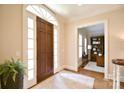 Light-filled foyer showcases an elegant doorway and glimpses of a wood-paneled study at 5827 Rileys Ridge Rd, Charlotte, NC 28226