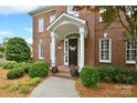 Charming front entrance features brick-paver steps, a covered porch, and meticulously maintained landscaping at 5827 Rileys Ridge Rd, Charlotte, NC 28226