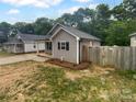 Well-maintained home with fenced yard and a freshly mulched flower bed in the front at 652 Wilson St, Kannapolis, NC 28083