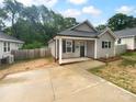 Inviting single-story home with a new concrete driveway, covered entry, and fresh landscaping at 652 Wilson St, Kannapolis, NC 28083