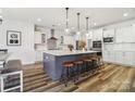 Bright kitchen boasts a large central island with seating, pendant lighting, and modern appliances at 754 Culp Ferguson Rd, Lancaster, SC 29720
