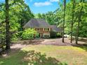 Charming brick home with a well-maintained lawn and mature trees, providing a serene and inviting curb appeal at 8524 Quarters Ln, Mint Hill, NC 28227