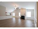 Spacious living room featuring a fireplace, vaulted ceilings, and hardwood floors at 9814 Fernspray Rd, Charlotte, NC 28215