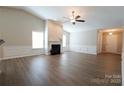 Bright living room boasting hardwood floors, a cozy fireplace, and abundant natural light at 9814 Fernspray Rd, Charlotte, NC 28215