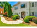 Close-up of the house's front entrance with a beautiful door, tasteful landscaping, and inviting walkway at 10327 Oak Pond Cir, Charlotte, NC 28277