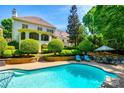 Backyard oasis with a sparkling swimming pool, patio area, and lush landscaping, perfect for outdoor enjoyment at 10327 Oak Pond Cir, Charlotte, NC 28277