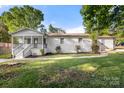 Side view of the home showcasing the white brick exterior and manicured lawn at 104 Berry St, Fort Mill, SC 29715