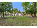 Wide shot of the home, revealing the spacious yard and mature trees at 104 Berry St, Fort Mill, SC 29715