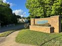 Stone sign for 'Bennington' neighborhood with manicured landscaping and a glimpse of homes in the background at 111 Tilton Dr, Mooresville, NC 28115