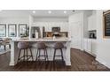 Modern white kitchen with a center island, stainless steel appliances, and stylish bar stool seating at 1113 Hallman Branch Ln, Lincolnton, NC 28092