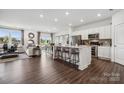 Open-concept living space with a modern kitchen, comfortable living area, and bright dining space at 1113 Hallman Branch Ln, Lincolnton, NC 28092