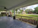View from the covered front porch showcasing the wood railings, stained decking, and the surrounding lawn at 1415 S York Rd, Gastonia, NC 28052