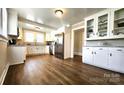 Spacious kitchen featuring modern appliances, wood flooring, and a view to the dining room at 169 Freeze Nw Ave, Concord, NC 28025