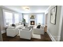 Bright living room with fireplace, hardwood floors, and ample natural light at 169 Freeze Nw Ave, Concord, NC 28025
