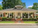 Inviting home exterior with charming front porch, showcasing a welcoming entrance and manicured landscaping at 170 8Th Ave, Cramerton, NC 28032