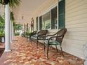 Inviting porch showcases mosaic tile flooring and plenty of seating to enjoy outdoor comfort at 170 8Th Ave, Cramerton, NC 28032
