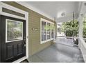 Inviting front porch with classic columns and a cozy porch swing at 1855 Second Baxter Xing, Fort Mill, SC 29708