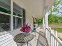 Inviting front porch with decorative plants, a table and chairs providing a relaxing outdoor space at 1904 Lark Ln, Stanley, NC 28164