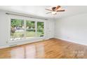Bright living room features hardwood floors and a large window offering a picturesque view at 205 Dogwood Ln, Dallas, NC 28034