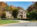 Lovely brick home with green shutters, mature trees and a well-maintained lawn at 2101 Congress Ct, Kannapolis, NC 28083