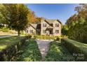 Beautiful brick home featuring manicured hedges leading to the front entrance at 2101 Congress Ct, Kannapolis, NC 28083