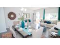 Dining area with table set for six, flowing into living space with ample light at 217 Giant Oak Ave, Statesville, NC 28677