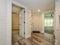 Bright foyer with wood-look flooring, white trim, and open doorways to living spaces at 233 Northwest Dr, Davidson, NC 28036