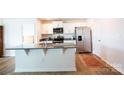 Bright kitchen with stainless steel appliances, white cabinets and a granite island at 2554 Goose Fair Rd, Maiden, NC 28650