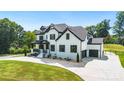 Beautiful two-story home with white brick, black trim, two-car garage and long driveway at 2854 Harlinsdale Dr, Rock Hill, SC 29732