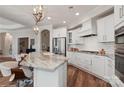 A spacious kitchen with a marble island, stainless appliances, and custom cabinetry at 3006 Portico Pl # 37, Fort Mill, SC 29715