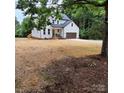 Charming two-story home with board and batten siding and a brown, two-car attached garage at 3114 Ansonville Rd, Marshville, NC 28103