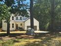 Charming two-story modern farmhouse with white siding, dark accents, and attached two car garage at 3114 Ansonville Rd, Marshville, NC 28103