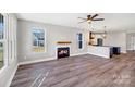 Open-concept living room with fireplace flows seamlessly into the kitchen, featuring modern finishes at 32507 Buchanan Ln, Albemarle, NC 28001