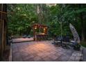 Charming outdoor kitchen and entertaining area with a pergola and stone patio at 4877 River Hills Dr, Denver, NC 28037