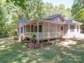 This lovely home offers a charming covered porch and nicely landscaped yard, great for outdoor enjoyment at 4901 Pine Oaks Dr, Monroe, NC 28112