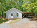 This outbuilding features covered parking and a storage area, adding functionality to the property at 4901 Pine Oaks Dr, Monroe, NC 28112