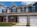 Charming brick townhomes with attached garages and manicured lawns at 5149 Tommy Ln # 1102, Stanley, NC 28164